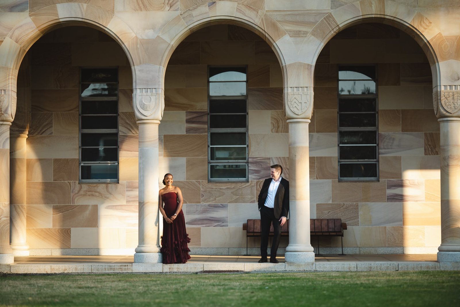 Nontobeko and Ville standing beneath sandstone arches